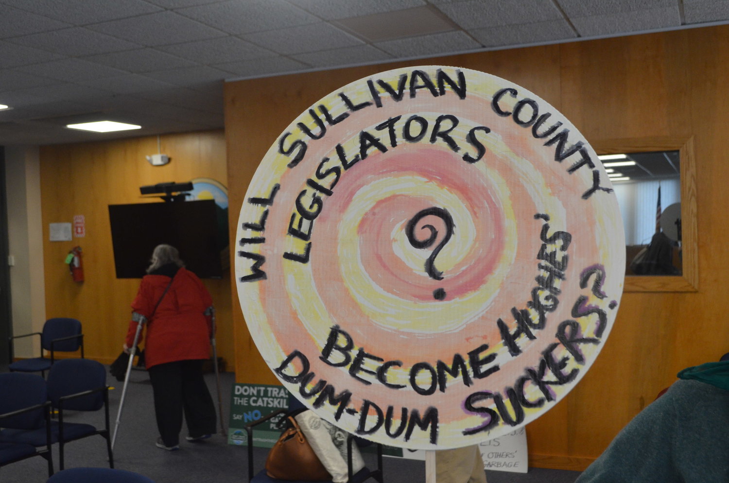 A sign held at the November 17 meeting of the Sullivan County Legislature asks if legislators will become “suckers” for Hughes Energy’s proposal.